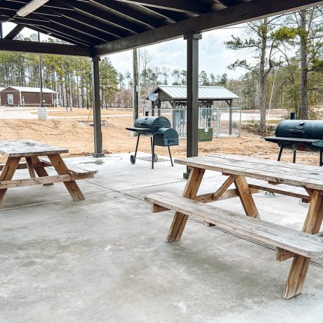 covered picnic table area with bbqs